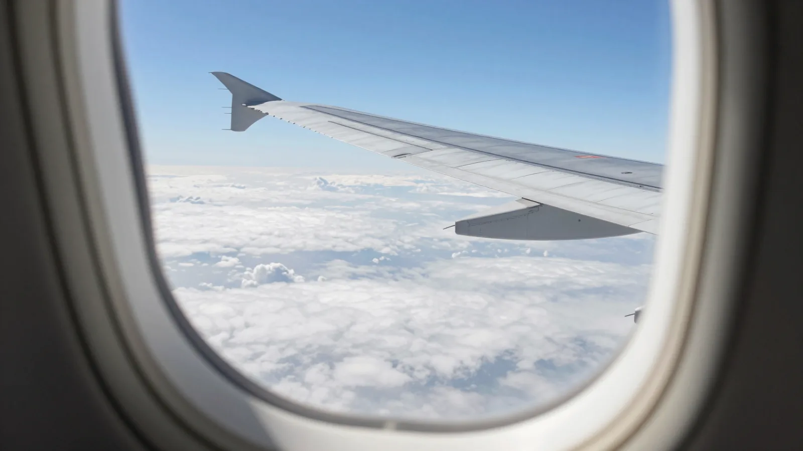 The view from an airplane window over the clouds