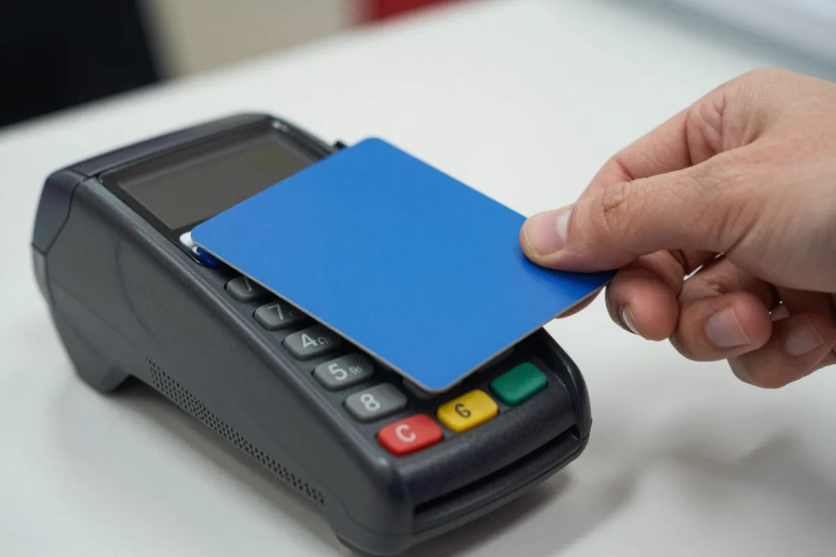 Paying with a debit card at a store terminal