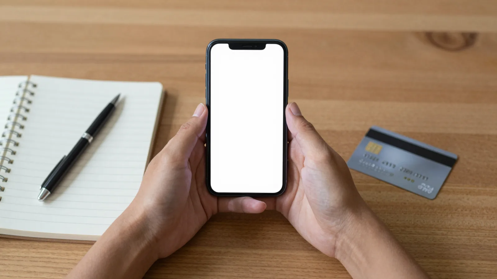 Checking a credit score on a smartphone at a desk