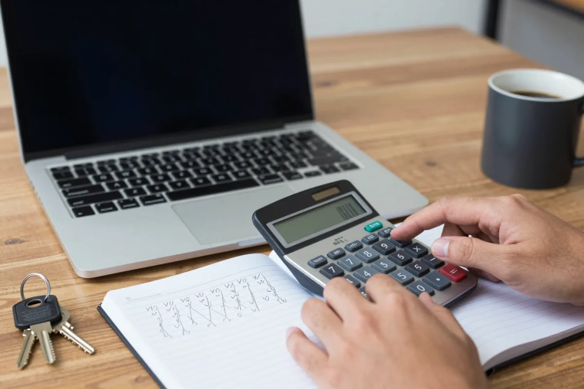 Working out a home budget with a calculator and notepad
