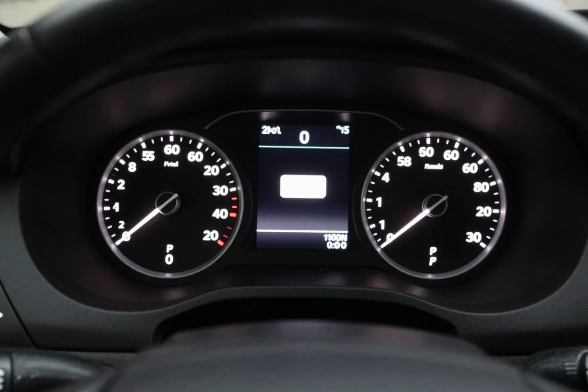A car's dashboard gauges, a reminder of lease mileage limits