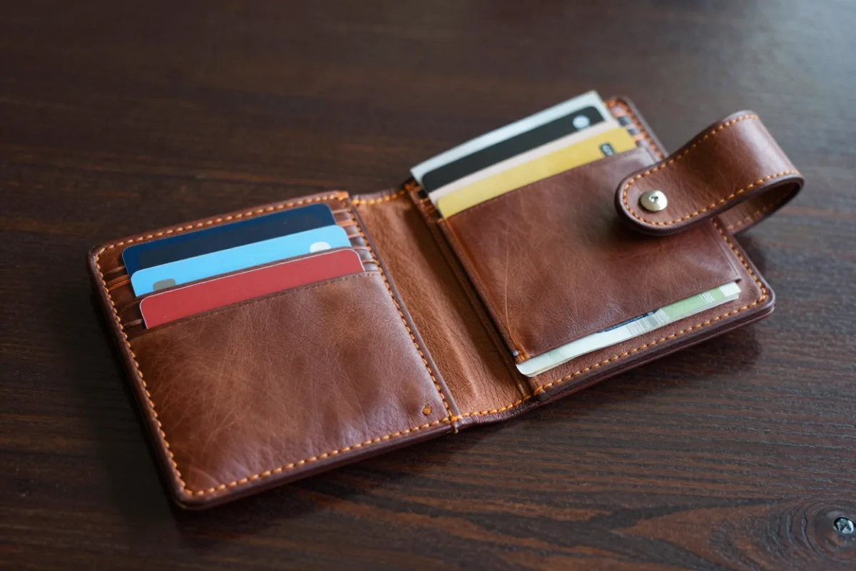 A travel wallet with two cards and a little cash